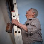Older man on a ladder