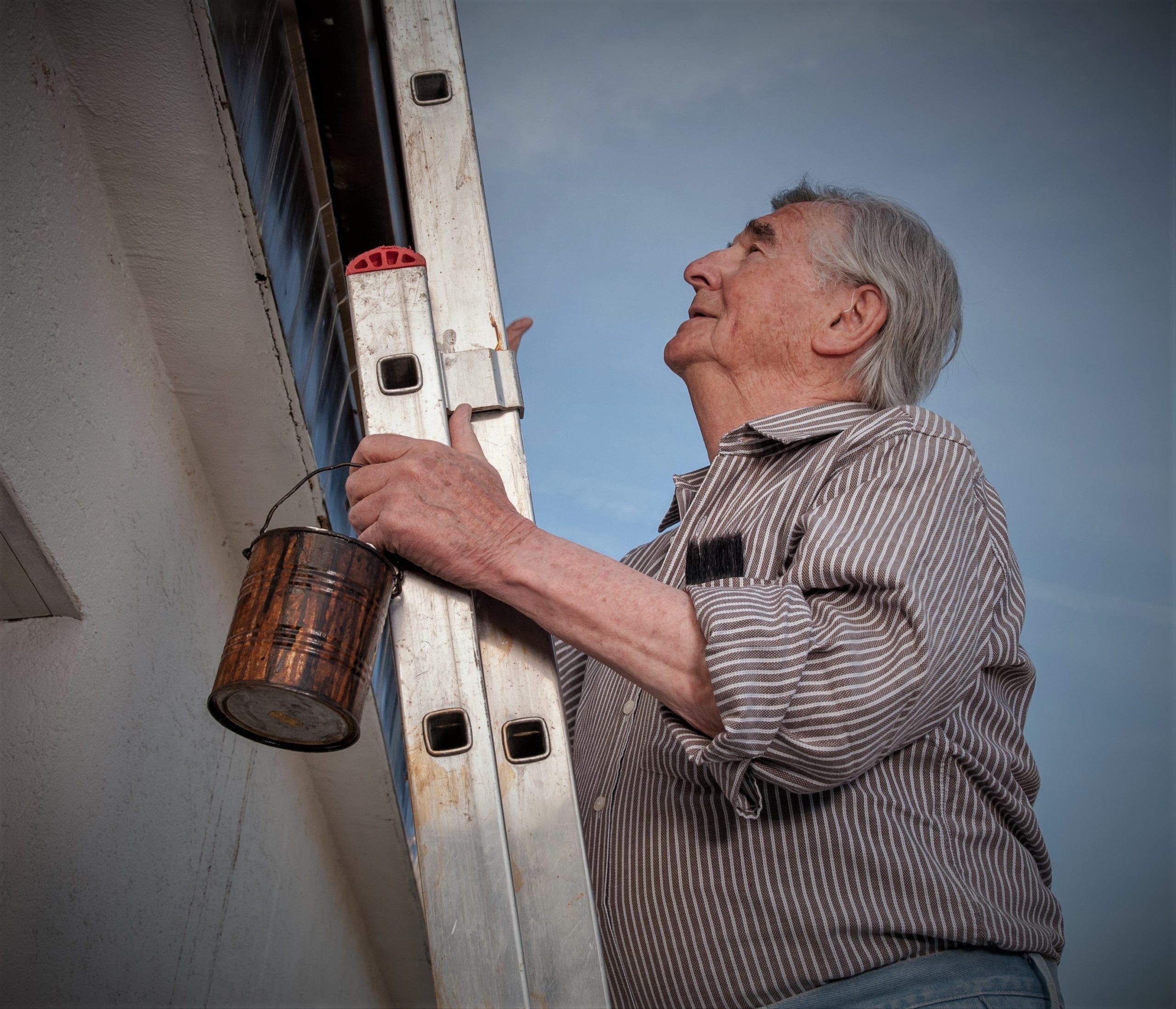 Older man on a ladder