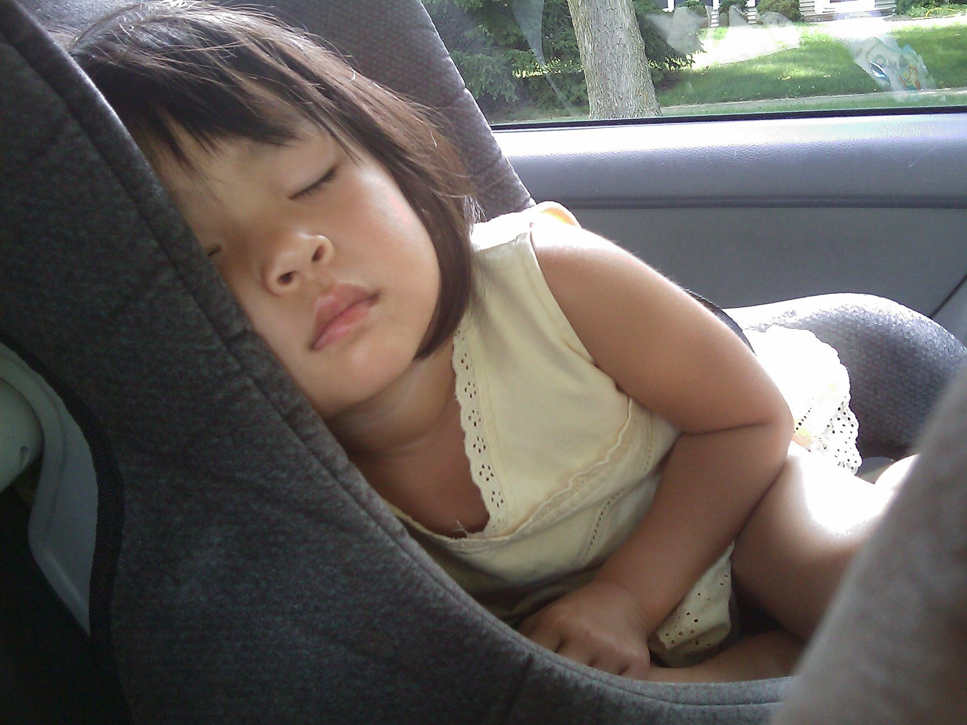 Toddler sleeping on a car seat